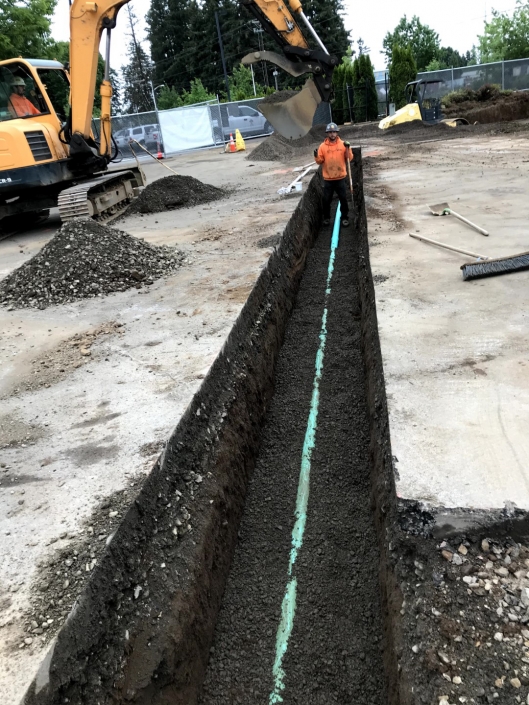 Tualatin Service Center excavation project in progress installing commercial sanitary line and concrete slab foundation for office building